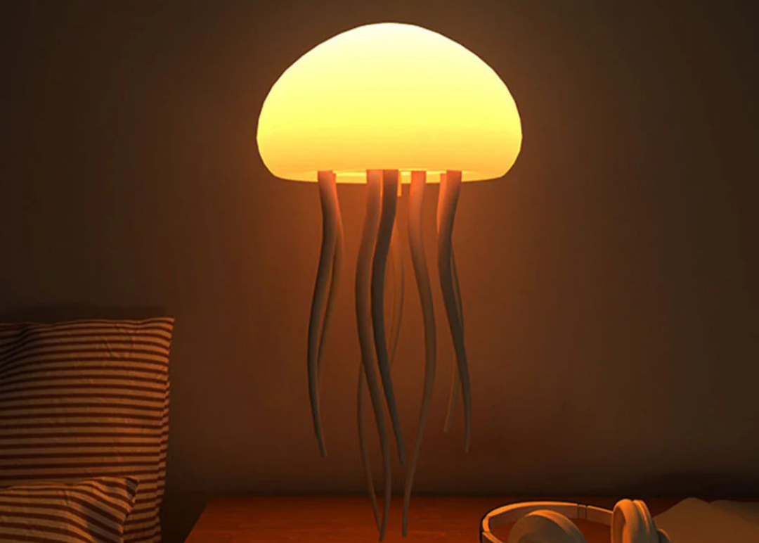 Jellyfish-shaped lamp with a warm glow on a dark background