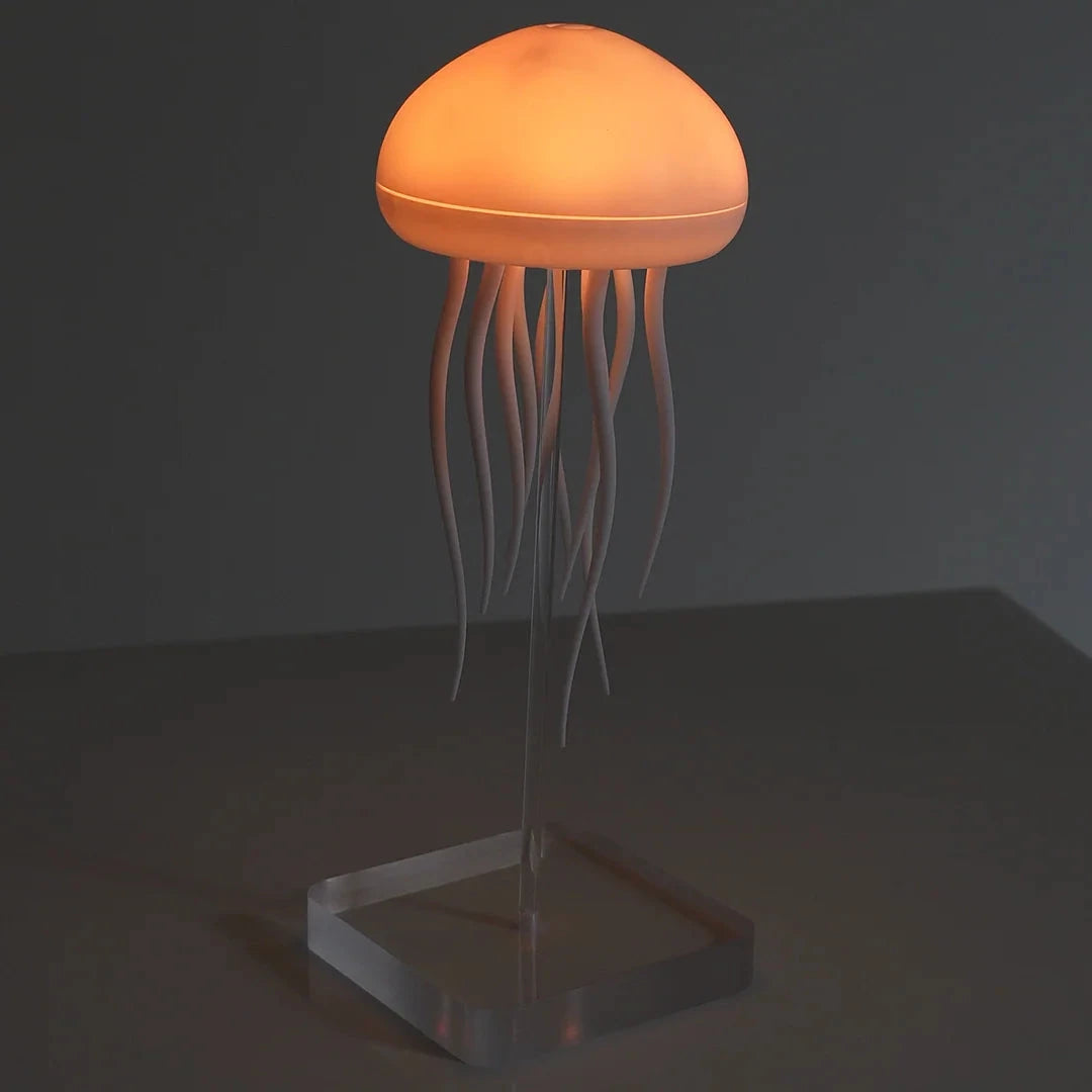 Jellyfish-shaped lamp with a warm glow on a dark background