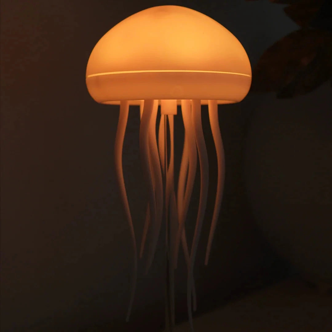 Jellyfish-shaped lamp emitting a warm glow against a dark background
